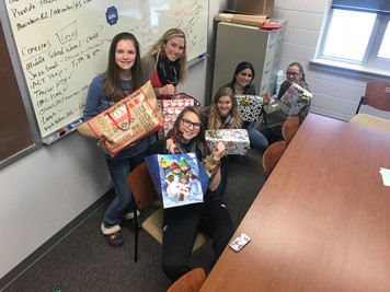 NHS Members Purchase and Wrap Gifts for Holiday Giving